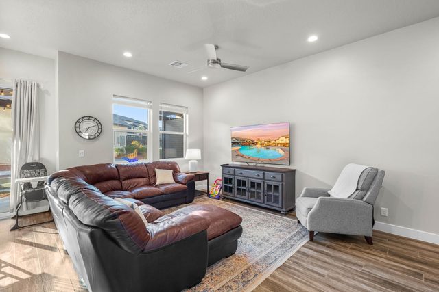 Leather sectional and armchair facing the living room TV