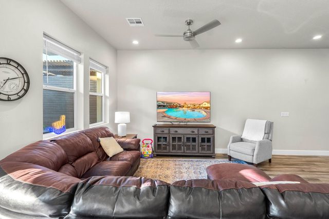 Living room sectional with TV console and ceiling fan