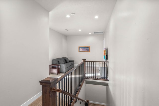 Upstairs loft landing with sofa above the staircase
