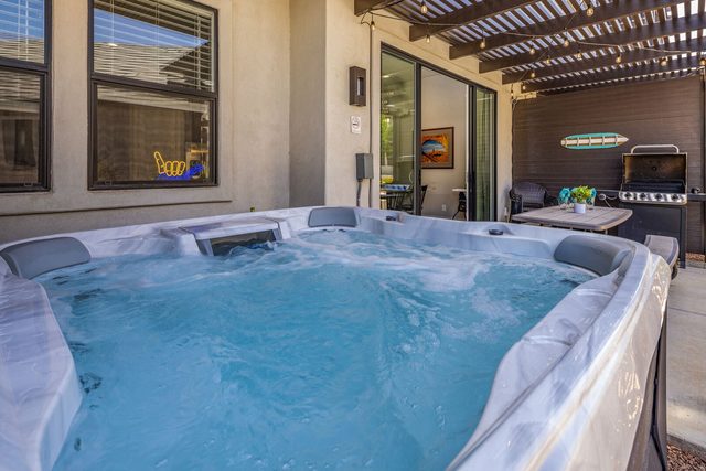 Private hot tub with patio and BBQ grill behind