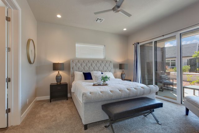 Main-level master bedroom with king bed at Pools Edge