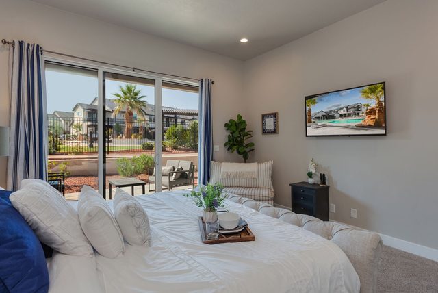 Master bedroom king bed with sliding door to private patio