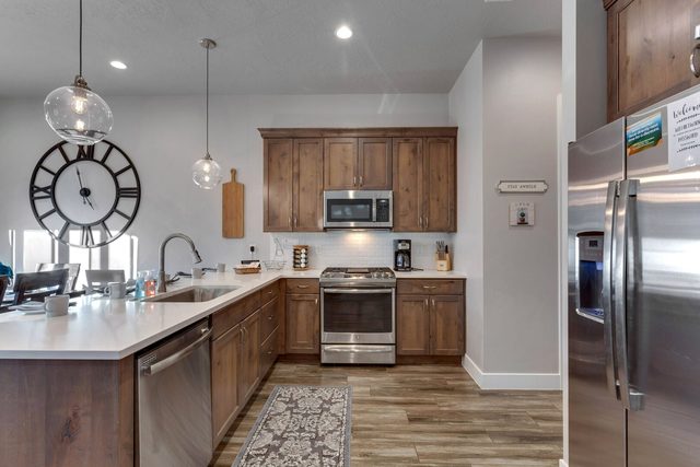 Kitchen with gas range, dishwasher and stainless refrigerator