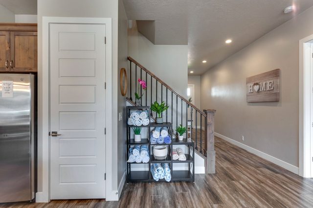 Entry hallway with staircase and beach towel rack