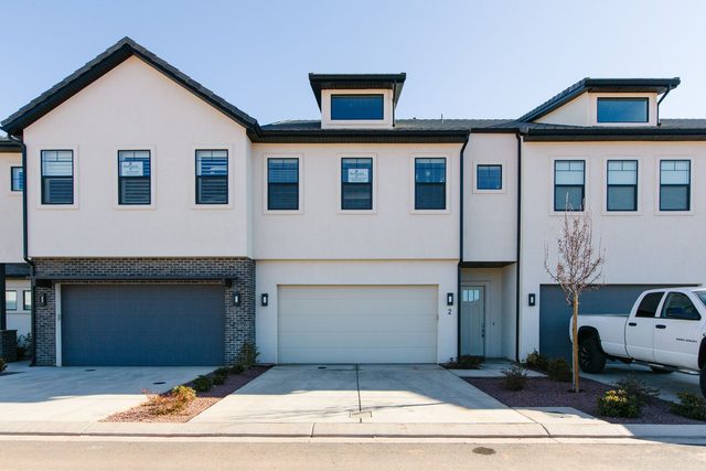 Front of Ocotillo Springs 2 townhome with two-car garage and driveway