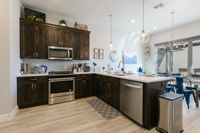Kitchen with dark wood cabinets and stainless steel appliances