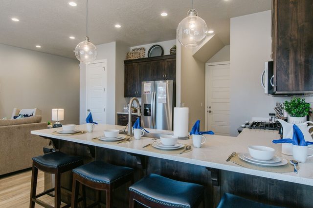Kitchen island with quartz counter and bar stool seating at Ocotillo Springs 2