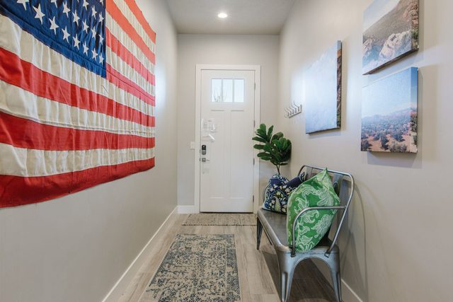 Entry hallway with bench and American flag wall art