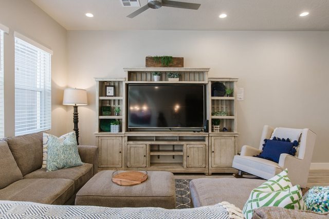 Living room sectional facing a large TV entertainment center