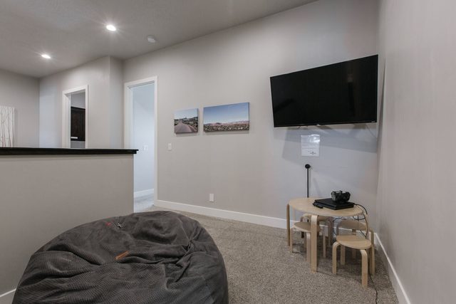 Upstairs loft with bean bag, kids table and wall TV