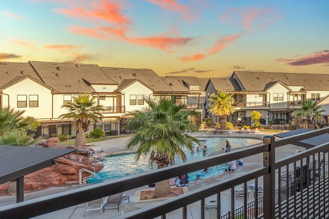 Balcony view over the resort pool and townhomes at sunset