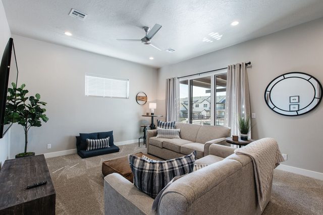 Upstairs loft with two sofas and sliding balcony door