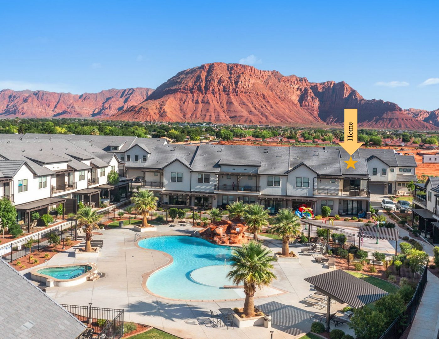 Aerial of the resort pool and red cliffs with the home marked
