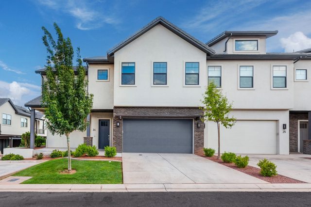 Front of Ocotillo Springs 24 with two-car garage and lawn