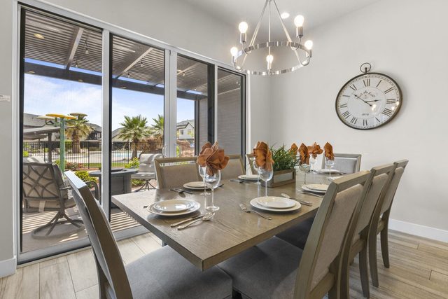 Dining table for eight beside sliding doors to the patio