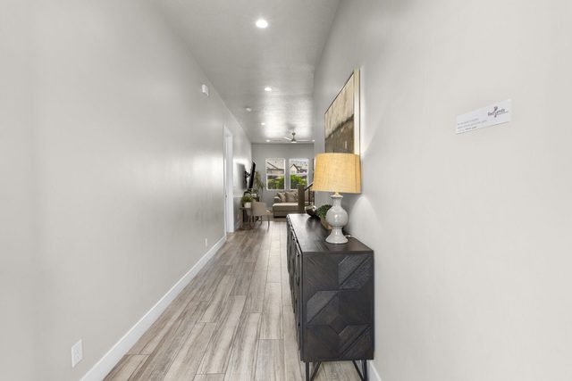 Entry hallway with wood-look floors leading to the great room