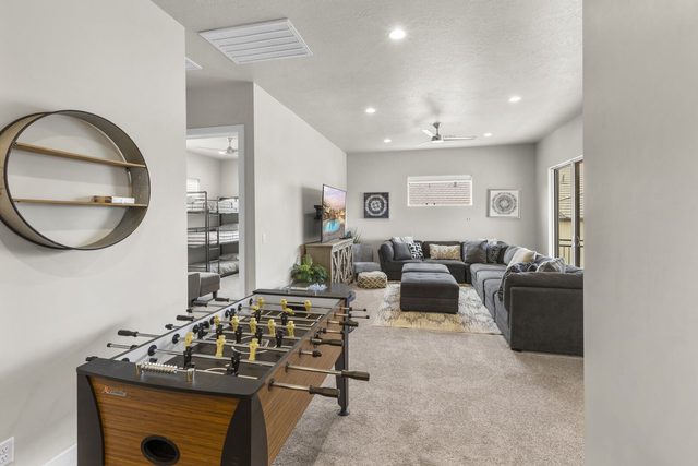 Upstairs loft with foosball table and gray sectional