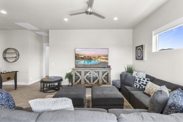 Loft seating area with sectional and TV on a console