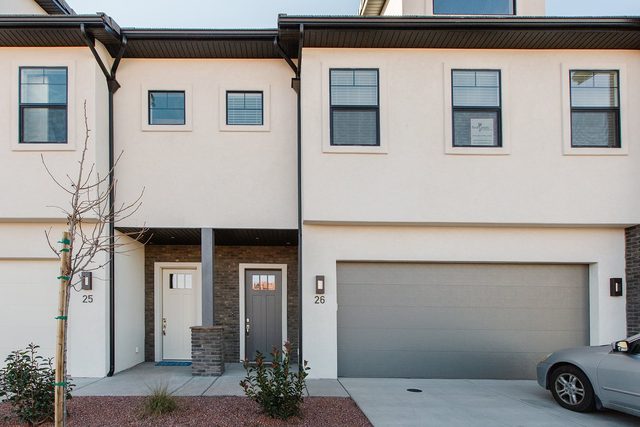 Front entry and two-car garage of Ocotillo Springs 26 townhome