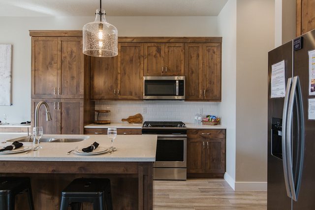 Wood cabinets, stainless range and refrigerator in the kitchen