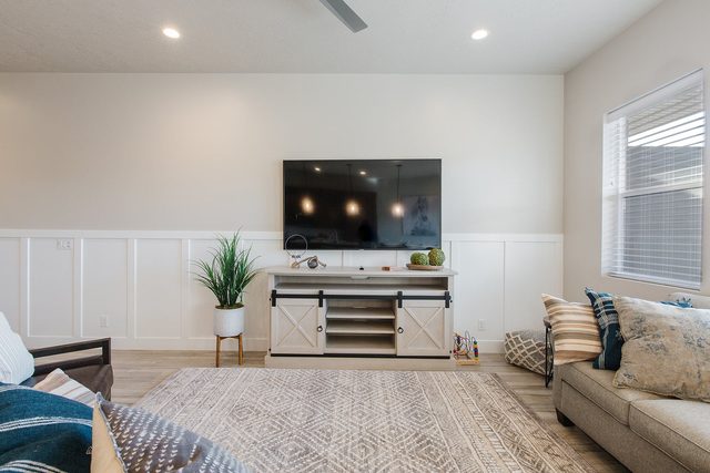 Living room wall-mounted TV above a farmhouse media console