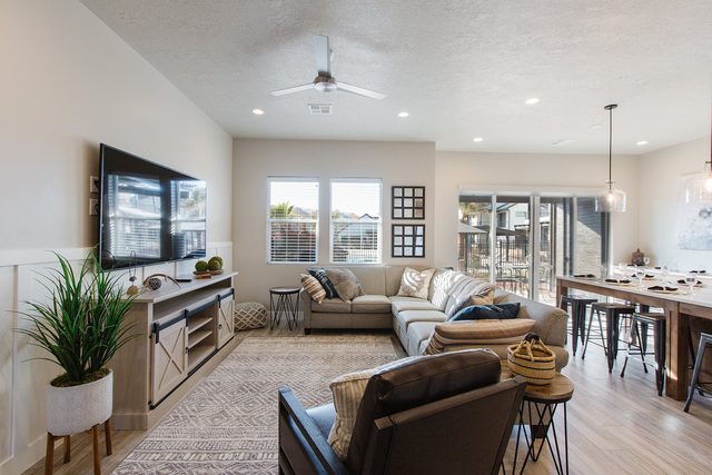 Great room with sectional, TV and dining area beyond