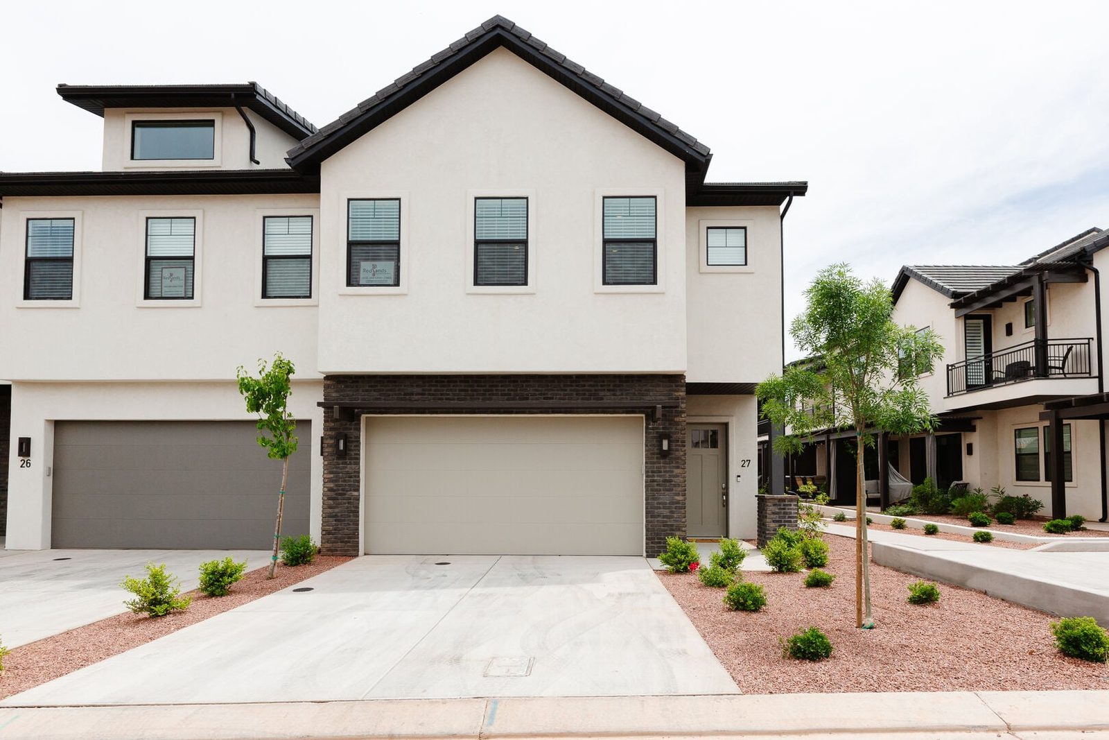 Front exterior of Ocotillo Springs 27 with two-car garage and driveway