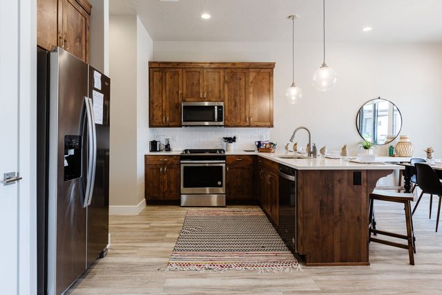 Kitchen with wood cabinets, stainless fridge and gas range