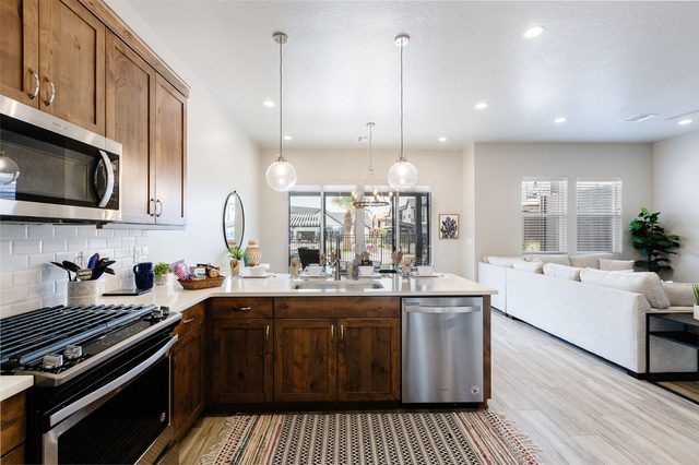 Kitchen gas range and island sink facing the living room