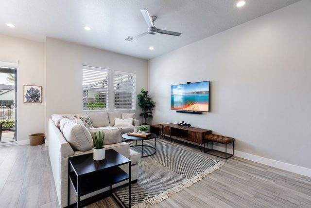 Living room sectional facing wall-mounted smart TV