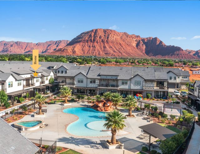 Aerial of the townhome row and resort pool below red cliffs