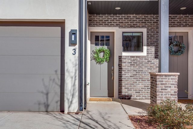 Front entry and two-car garage door of Ocotillo Springs 3