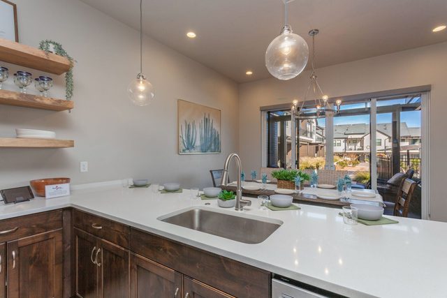 Quartz kitchen counter and sink looking toward the dining area