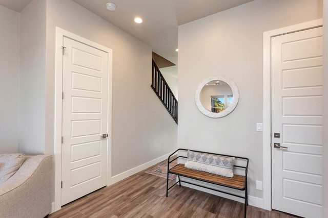 Entry hallway with bench, mirror and staircase to the loft