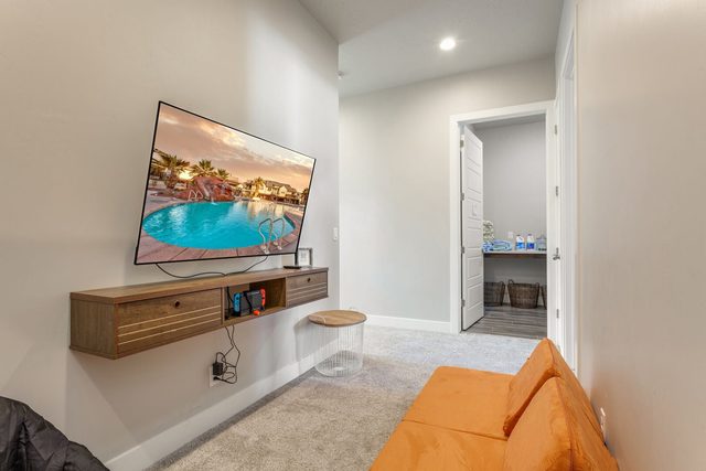 Loft lounge with TV console and orange floor cushions