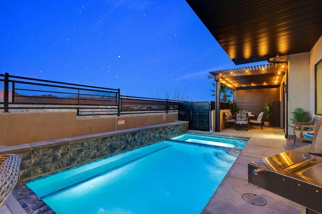 Private pool and patio lit at night at Ocotillo Springs 32