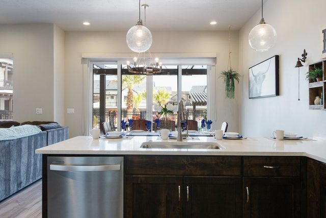 Kitchen island sink facing sliding doors to the patio