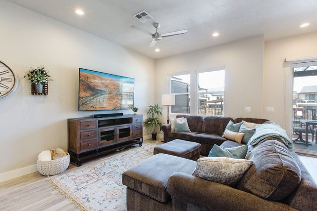 Living room sectional facing a TV and media console