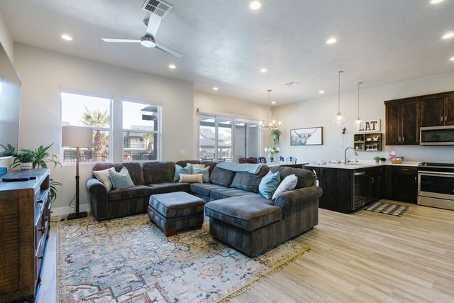 Open living room with large sectional and kitchen behind at Ocotillo Springs 4