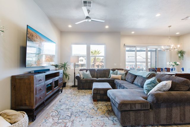 Living room with sectional, rug and wall-mounted TV