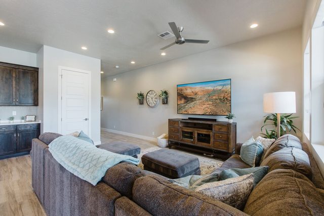 Living room sectional and TV console at Ocotillo Springs 4
