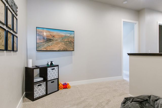 Upstairs loft with wall TV and storage cubbies