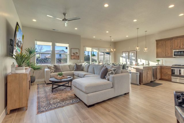 Open living room with sectional sofa flowing into the kitchen