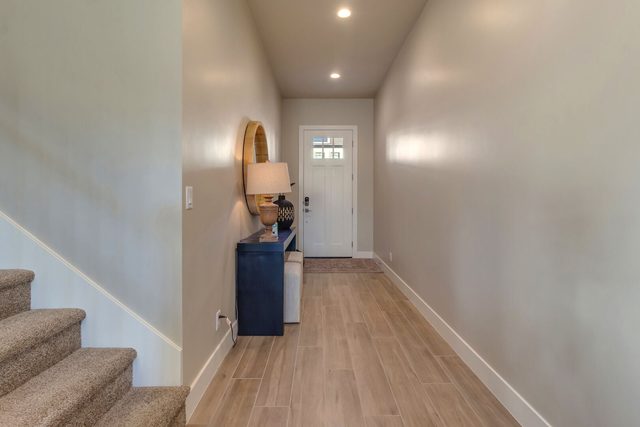 Entry hallway with staircase leading to the upstairs loft