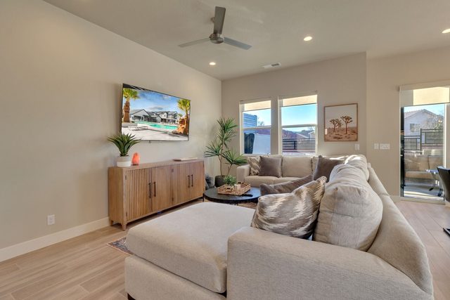 Living room sectional facing a wall-mounted smart TV