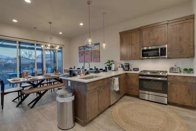 Kitchen with peninsula, stainless range and dining area at Ocotillo Springs 42