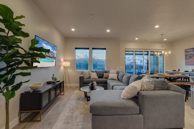 Main living room with sectional sofa and wall TV at Ocotillo Springs 42