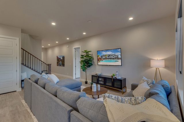 Living room sectional facing TV near staircase at Ocotillo Springs 42