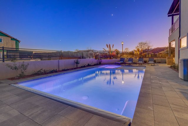 Private pool lit at twilight with patio loungers at Ocotillo Springs 42