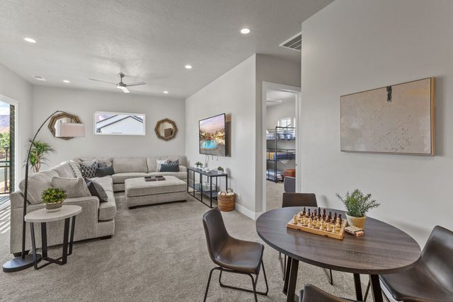 Upstairs lounge with sectional sofa and round game table